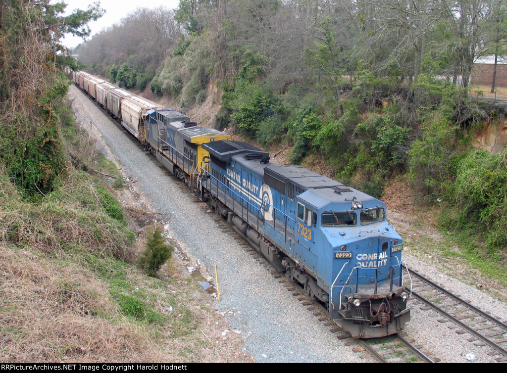 CSX 7323 leads a grain train held at Rice Street